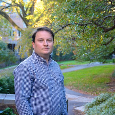 A man in a blue shirt in a garden